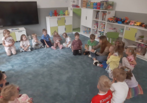 Dzieci słuchające książki czytanej przez jedną z mam