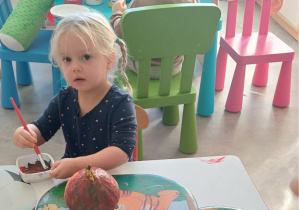 dziewczynka maluje dynię