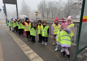dzieci w kamizelkach odblaskowych w drodze na zajęcia judo
