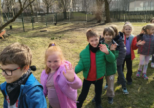 Dzieci podczas spaceru w korowodzie po ogrodzie przedszkolnym
