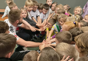Dzieci z Panem Piąteczką przygotowują się do wykonania wspólnego okrzyku na cześć piłkarzy