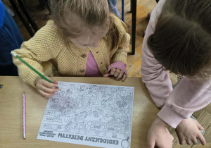 Dziewczynka rozwiązuje kartę pracy