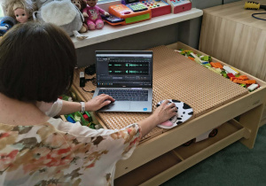 Pani montuje na laptopie zebrane wypowiedzi dzieci